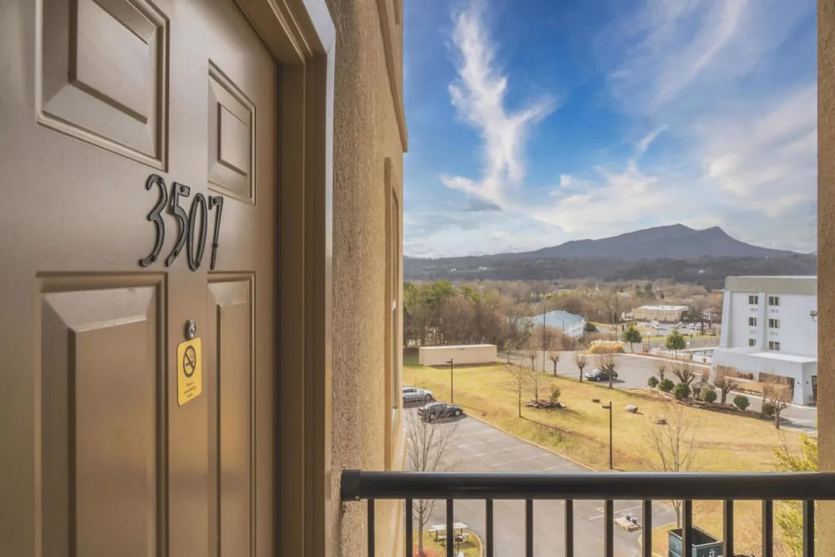 The photo shows a balcony view with a clear sky and sweeping mountains in the distance. The door marked '3507' is visible, and the balcony provides a spot for guests to relax and take in the scenery or prepare for a day of adventure.